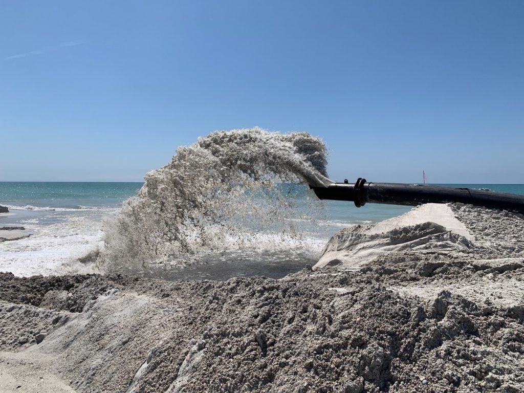 A photograph of the sand slurry discharge along the shoreline at Gulfside Road, Longboat Key, FL (photo March 24th, olsen associates, inc.)